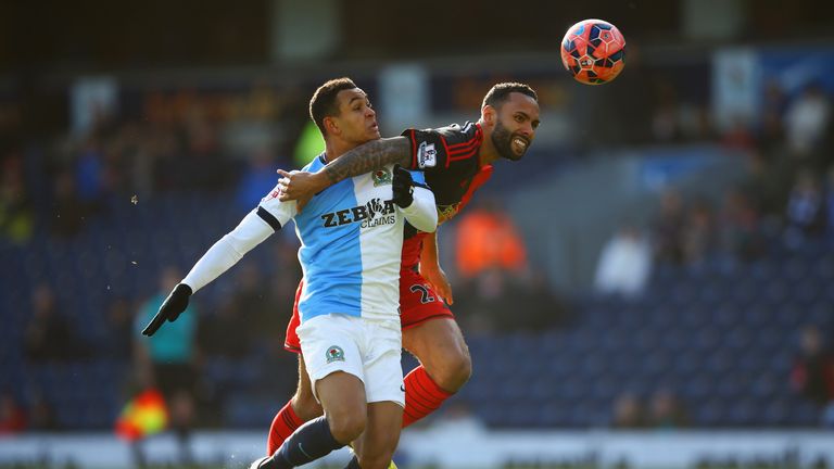 BLACKBURN, ENGLAND - JANUARY 24:  Kyle Bartley of Swansea City tangles with Joshua King of Blackburn Rovers  during the FA Cup Fourth Round match between B