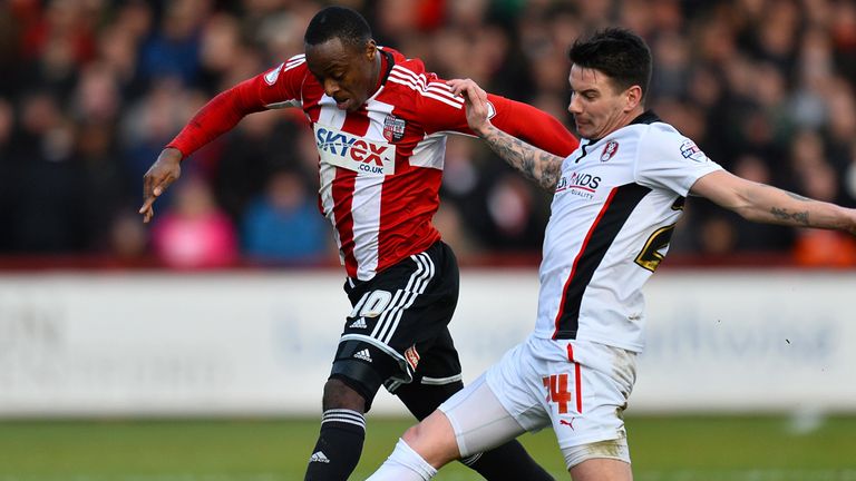 Moses Odubajo of Brentford and  Adam Hammill of Rotherham in action 