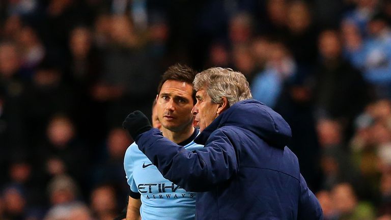 Manuel Pellegrini, manager of Manchester City, speaks with Frank Lampard as he prepares to come on