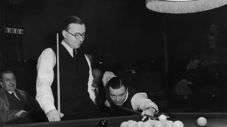 24th February 1939:  Snooker champion, Joe Davis taking a shot watched by his younger brother Fred at the World Snooker Championship semi-finals at Thornto