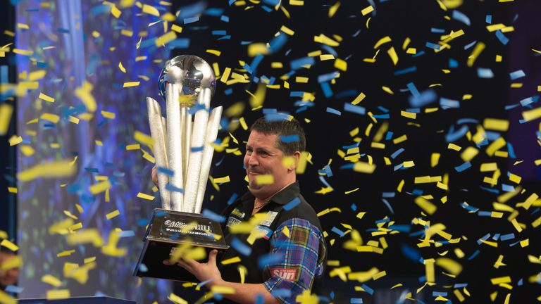 Gary Anderson celebrates with the Sid Waddell trophy after defeating Phil Taylor during the William Hill World Darts Championship at Alexandra Palace, Lond