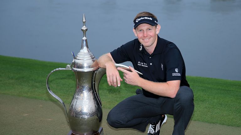 Stephen Gallacher of Scotland with the trophy after the final round where he became the first back to back winner of the Dubai Desert Classic