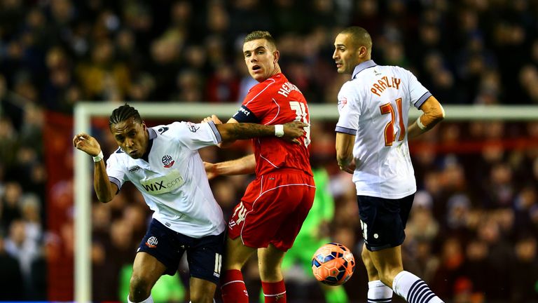 LIVERPOOL, ENGLAND - JANUARY 24:  Jordan Henderson of Liverpool battles for the ball with Neil Danns and Darren Pratley of Bolton Wanderers during the