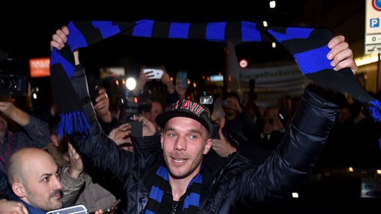 Lukas Podolski arrives to a mob of Inter supporters