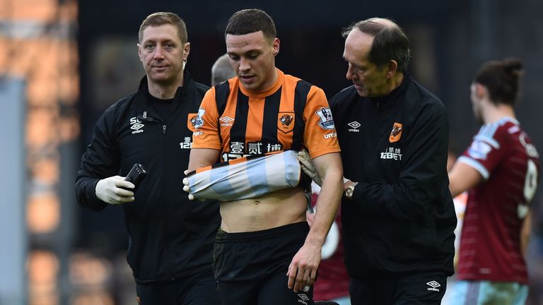 James Chester is helped from the pitch after picking up an injury during the English Premier League football match between West Ham United and Hull City