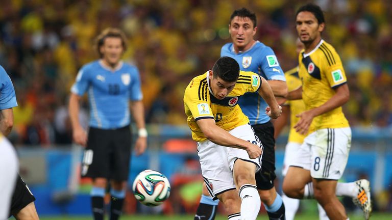 James Rodriguez of Colombia shoots and scoores against Uruguay