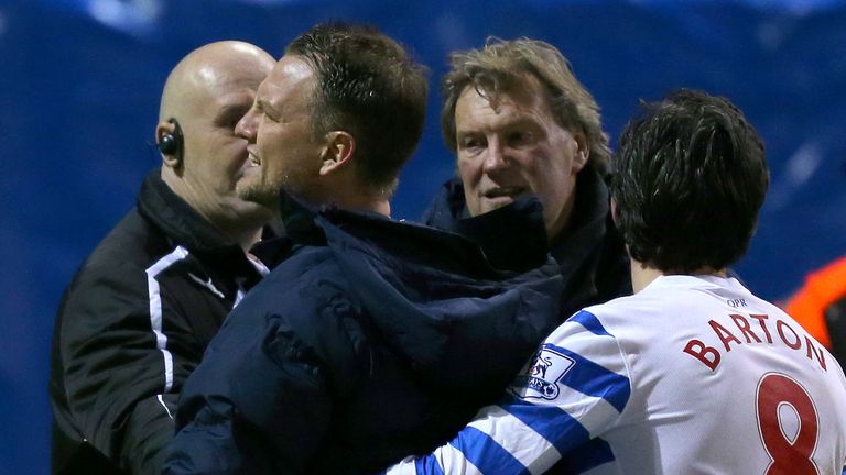 Clint Hill is pulled away by coach Glenn Hoddle and Joey Barton as he clashes with fans at Burnley