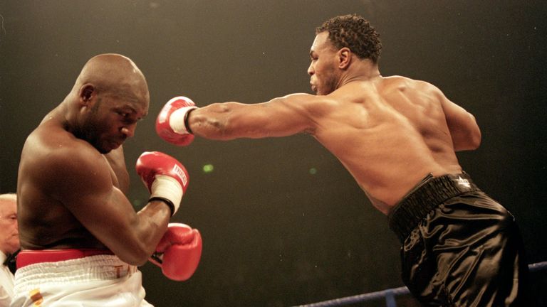 29 Jan 2000:  Mike Tyson (right) throws a left hand at Julius Francis during the heavyweight contest at the Manchester Evening News Arena in Manchester