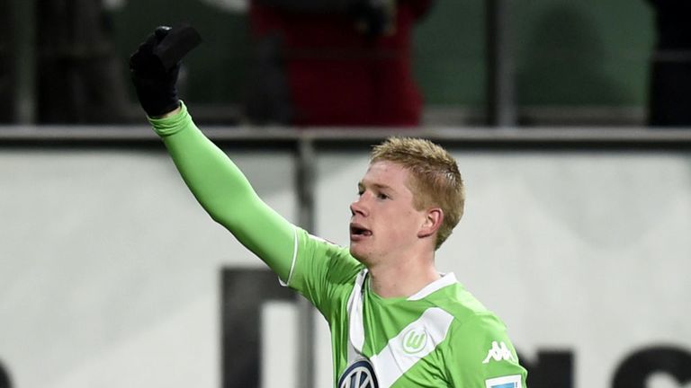 Wolfsburg's Kevin De Bruyne celebrates against Bayern Munich by holding his black armband aloft in tribute to Junior Malanda
