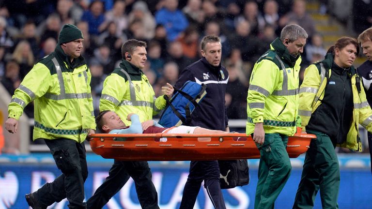 Burnley's Kevin Long is taken off injured during the Barclays Premier League match at St James' Park, Newcastle.