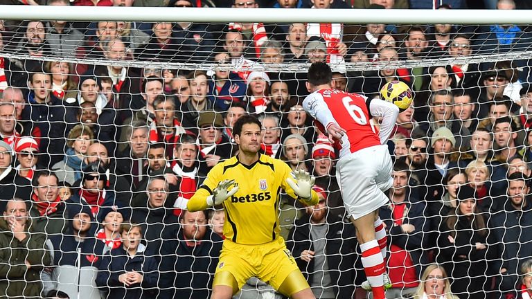 Laurent Koscielny heads the opening goal past Stoke City's goalkeeper Asmir Begovic.