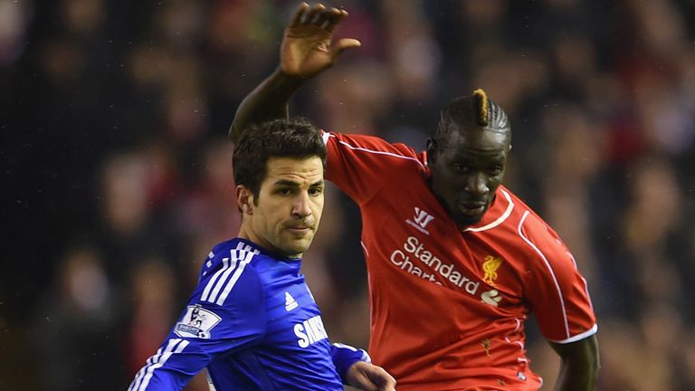 Cesc Fabregas attempts to block a shot from Liverpool's Mamadou Sakho