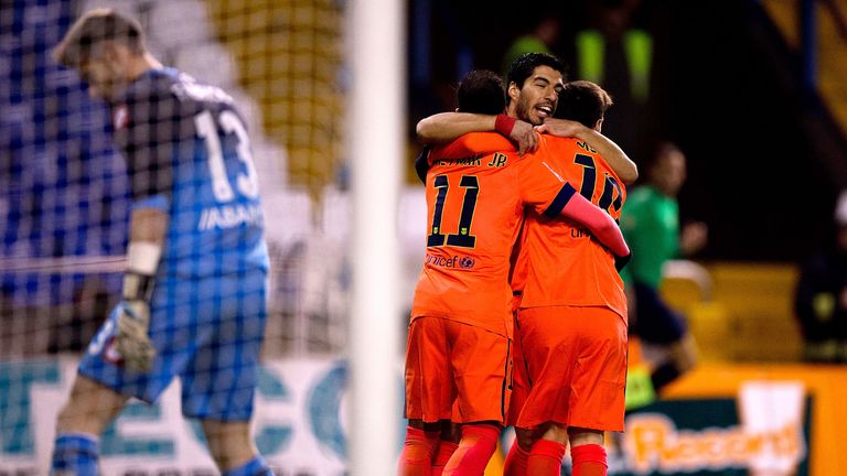 Lionel Messi (R) of FC Barcelona celebrates scoring their opening goal with teammate Neymar JR. (L) and Luis Suarez (2ndL) v Deportivo La Coruna