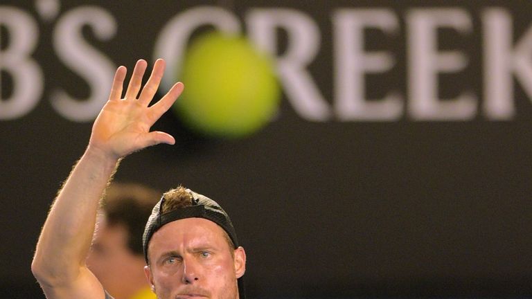 Lleyton Hewitt waves to the crowd as he leaves the court