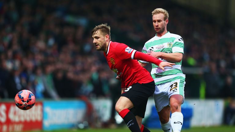 Luke Shaw of Manchester United holds off Simon Gillett of Yeovil Town during the FA Cup Third Round match at Huish Park