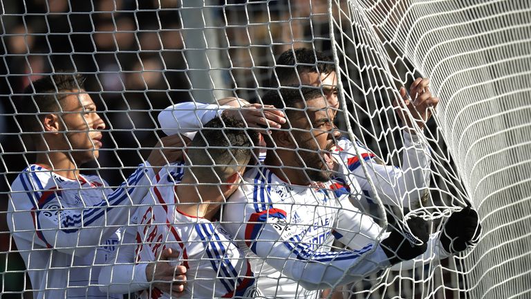 Lyon's French forward Alexandre Lacazette (R) celebrates with teammates after scoring during the French L1 football match Olympique Lyonnais vs FC Metz