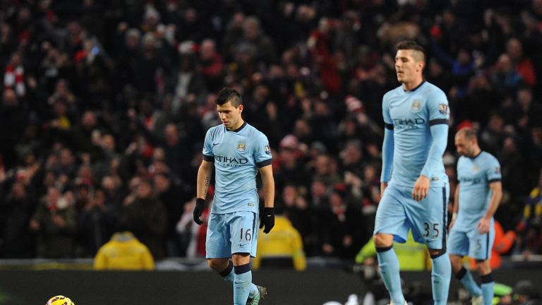 Manchester City's Argentinian striker Sergio Aguero (L) reacts after Arsenal score their second goal 