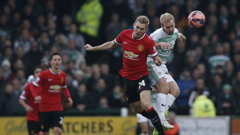 Manchester United's midfielder Darren Fletcher (L) and Yeovil Town's midfielder Simon Gillett (R) contest a high ball during the English FA Cup third round