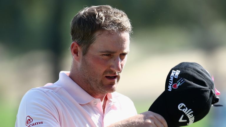 Marc Warren of Scotland acknowledges the crowd on the 18th green during the second round of the Omega Dubai Desert Classic