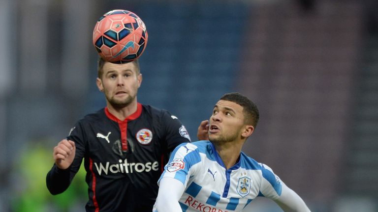 Nahki Wells of Huddersfield and Oliver Norwood of Reading battle for the ball during the FA Cup Third Round match