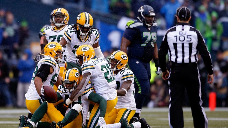 Morgan Burnett Green Bay Packers celebrates with teammates after making an interception v Seattle