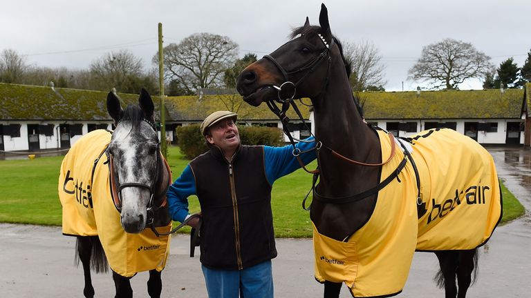 Trainer Nicky Henderson shows off Vasco Du Ronceray (L) and Sign Of A Victory ahead of the Betfair Hurdle at Newbury