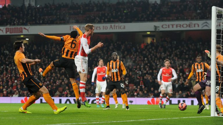 Arsenal's Per Mertesacker scores their first goal against Hull City during the FA Cup third round match at the Emirates Stadium, London