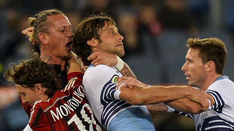 AC Milan's defender from France Philippe Mexes (2nd L) fights with Lazio's midfielder Stefano Mauri (C) during the Italian Serie A match Lazio vs AC Milan
