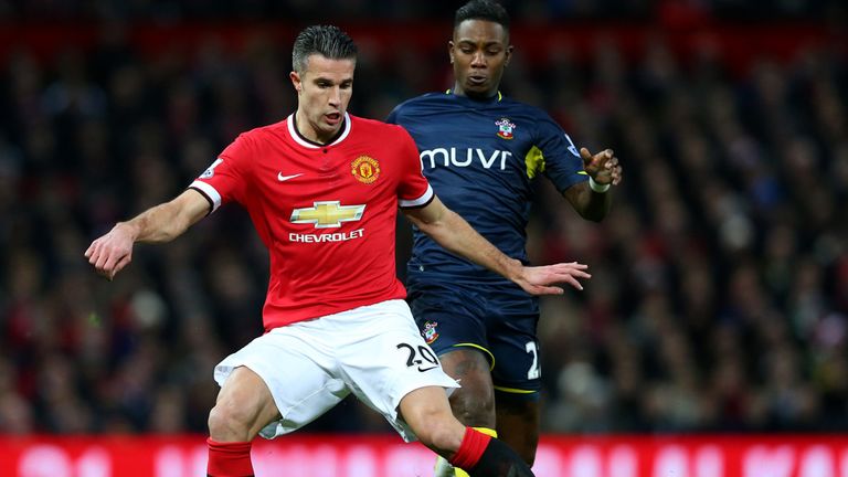 Robin van Persie of Manchester United passes the ball under pressure from Eljero Elia