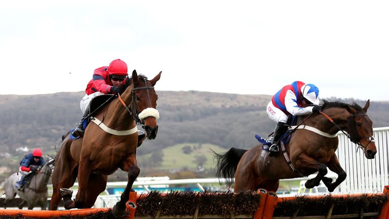 Thomas Brown ridden by Noel Fehily (right) jumps the last with Robinsfirth ridden by Brendan Powell (centre) on their way to victory at Cheltenham.