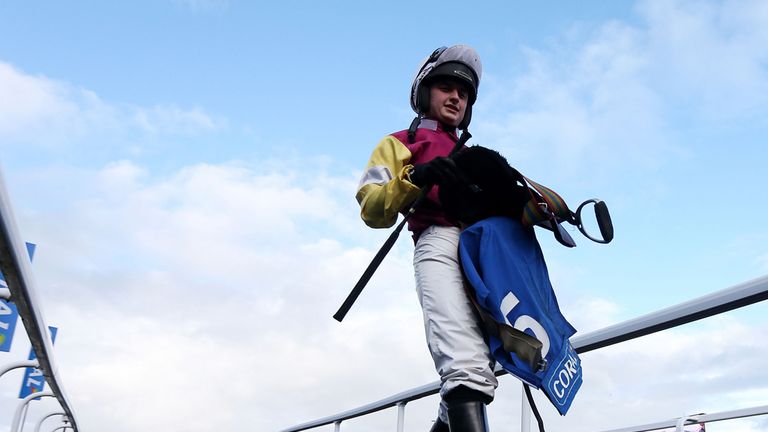 Jockey Sean Bowen makes his way in after his victory in the Coral Supporters Of British Horse Racing Handicap Hurdle during Coral Welsh Grand National.