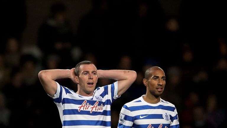 The dejected Richard Dunne and Karl Henry of QPR look on after conceding an injury time equaliser during the Barclays Premier League v Swansea