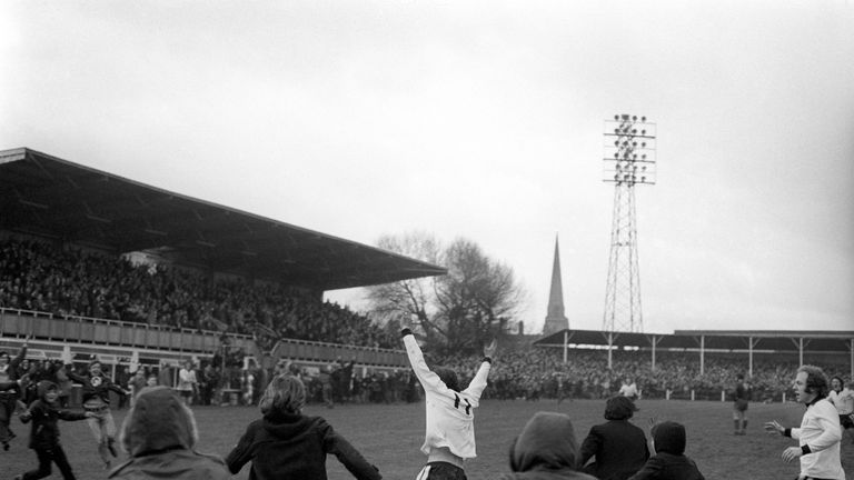 Hereford United's Ronnie Radford is pursued by hundreds of young fans, and teammate Ricky George after equalising against Newcastle in the 1972 FA Cup tie