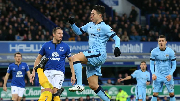 Goalkeeper Joel Robles of Everton pounces on the ball under pressuree from Samir Nasri 