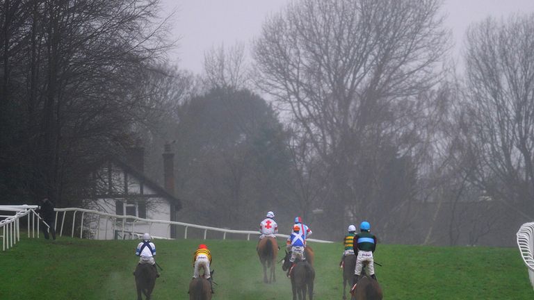 ESHER, ENGLAND - JANUARY 03: Runners pull up after finishing The 32RedSport.com Handicap Steeple Chase at Sandown racecourse.