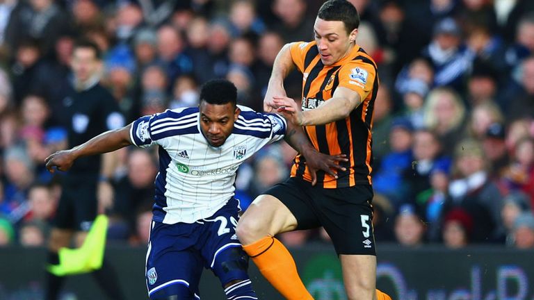 Stephane Sessegnon of West Brom holds off James Chester of Hull 