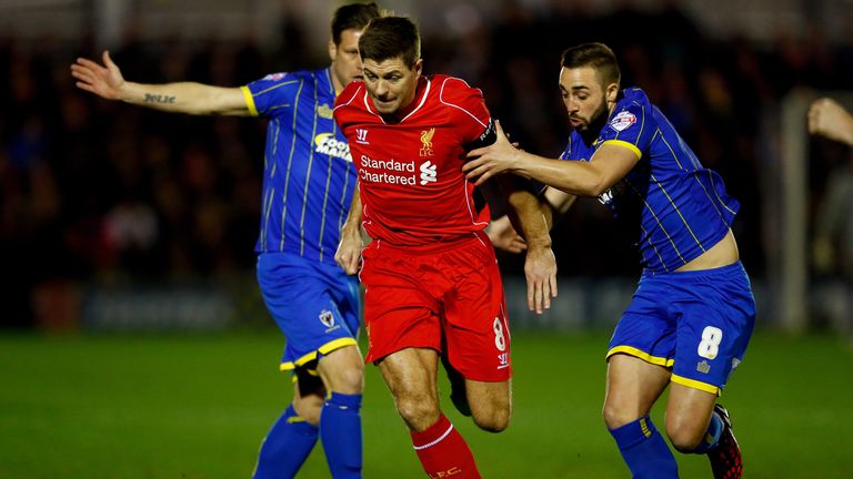 KINGSTON UPON THAMES, ENGLAND - JANUARY 05:  Steven Gerrard of Liverpool goes past Sammy Moore of AFC Wimbledon