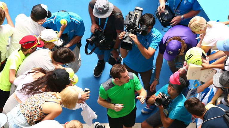 Andy Murray signs autographs after winning in his match against Marinko Matosevic