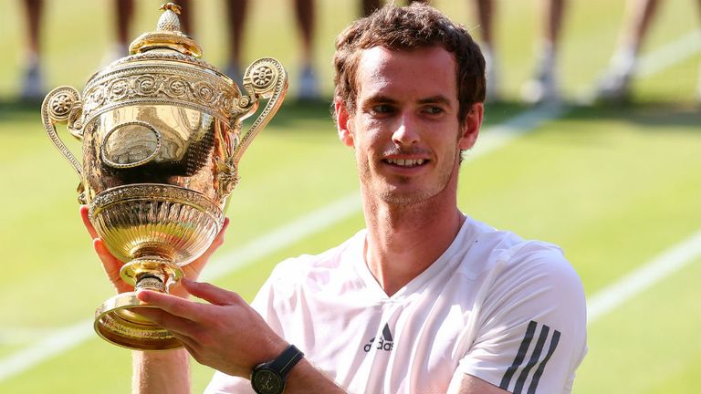 Andy Murray poses with the Wimbledon trophy following his victory against Novak Djokovic