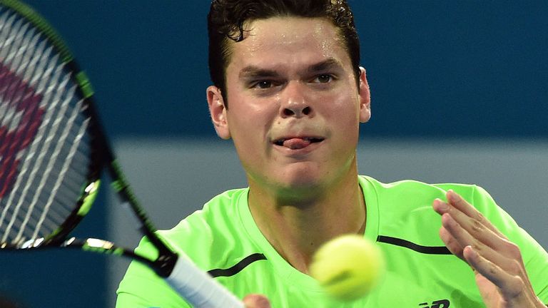 Milos Raonic hits a return against Roger Federer during their men's single final of the Brisbane International