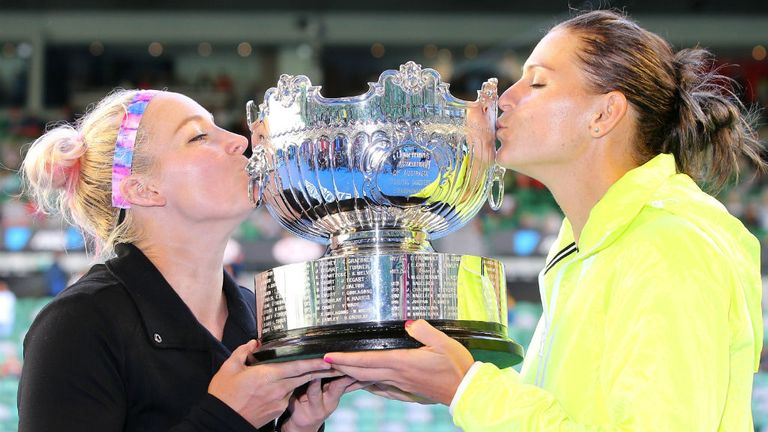 Bethanie Mattek-Sands and Lucie Safarova hold the trophy after winning their doubles final match at 2015 Australian Open
