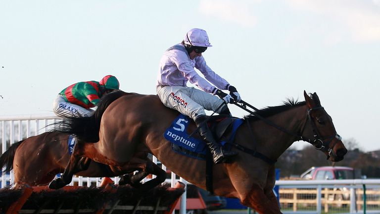 Three Musketeers ridden by Harry Skelton jumps the last on their way to victory in the Neptune Investment Management Novices´ Hurdle on Betfred Class