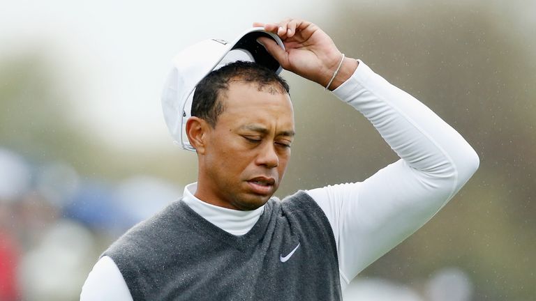 Tiger Woods waits on the ninth green after marking his golf ball during the second round of the Waste Management Phoenix Open