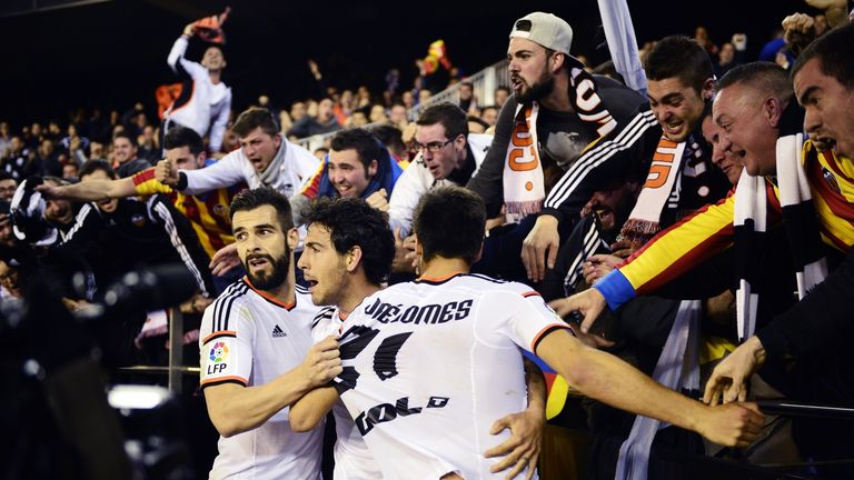 Valencia's midfielder Dani Parejo (C) celebrates his second goal with teammates and fans during the Spanish league football match Valencia vs Sevilla