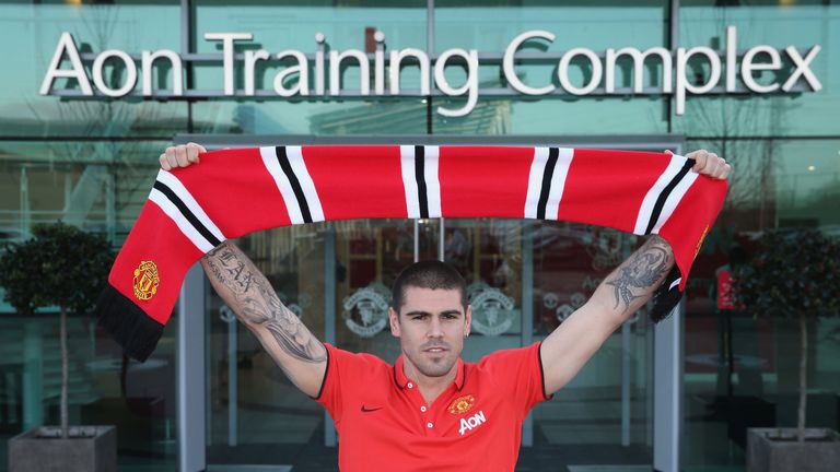Victor Valdes of Manchester United poses with a scarf after signing for the club at Aon Training Complex on January 8, 2015 in Manchester, England