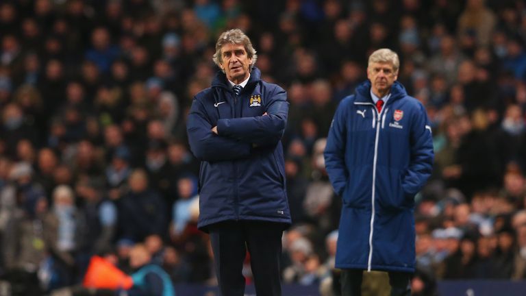 MANCHESTER, ENGLAND - JANUARY 18:  Manuel Pellegrini manager of Manchester City and Arsene Wenger manager of Arsenal look on from the touchline 
