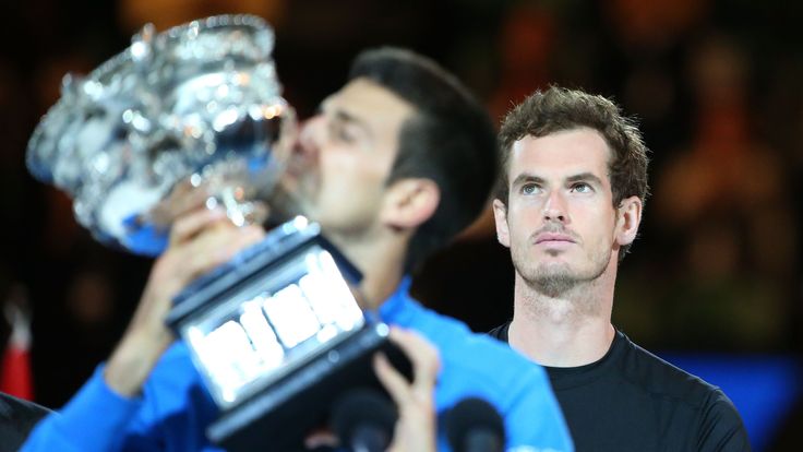 Andy Murray of Great Britain looks on as Novak Djokovic of Serbia holds the Norman Brookes Challenge Cup after he won the Australian Open final