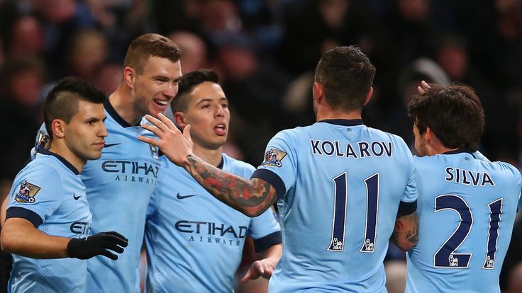 Man City players celebrate with Edin Dzeko after he scores against Newcastle