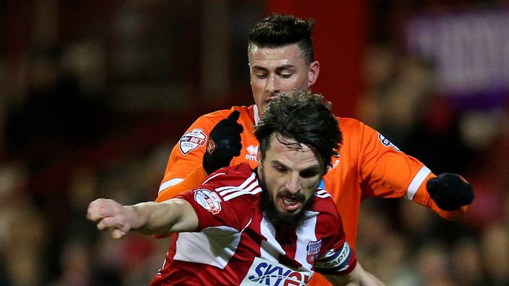 BRENTFORD, ENGLAND - FEBRUARY 24:  Jonathan Douglas of Brentford is pursued by Gary Madine of Blackpool during the Sky Bet Championship match between Brent
