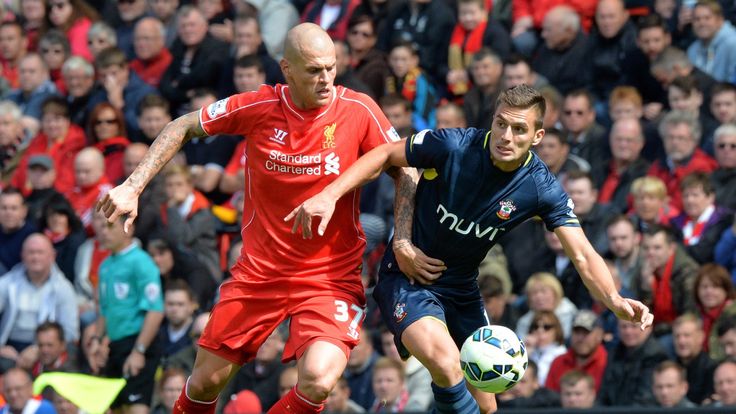 Southampton midfielder Dusan Tadic (R) vies for the ball with Liverpool defender Martin Skrtel